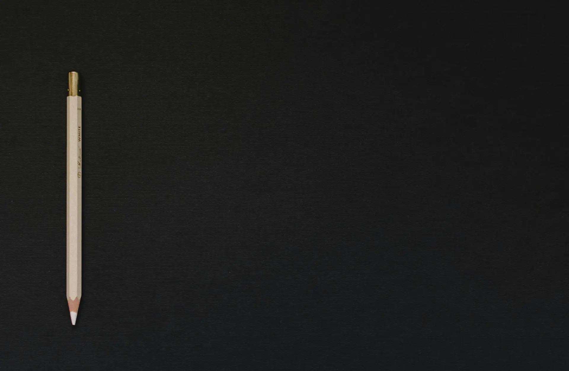 white pencil on black platform